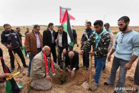Demonstrators holding Palestinian flags chant slogans during a rally marking Land Day, near the Israeli border with central Gaza Strip March 30, 2016. March 30 marks Land Day, the annual commemorations of the killing by...