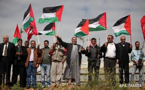 Demonstrators holding Palestinian flags chant slogans during a rally marking Land Day, near the Israeli border with central Gaza Strip March 30, 2016. March 30 marks Land Day, the annual commemorations of the killing by...