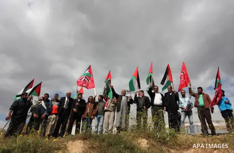 Demonstrators holding Palestinian flags chant slogans during a rally marking Land Day, near the Israeli border with central Gaza Strip March 30, 2016. March 30 marks Land Day, the annual commemorations of the killing by...