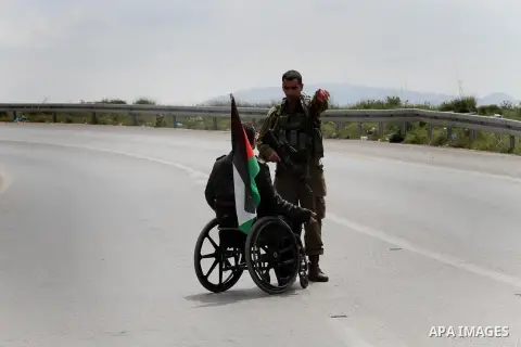 A Palestinian disabled argues with Israeli security forces during clashes following a rally marking Land Day in the West Bank village of Burqa near Nablus on March 30, 2016. March 30 marks Land Day, the annual commemorat...
