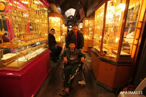 Palestinians walk past jewellery stores in Gaza city on March 30, 2016. The director of the Palestinian Authority’s borders and crossings department, Nathmi Muhanna said that Israeli authorities notified his department t...