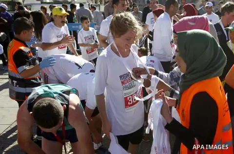 Participants run past the controversial Israeli barrier during the annual Right to Movement Palestine Marathon in the West Bank town of Bethlehem April 1, 2016. Photo by Wisam Hashlamoun
