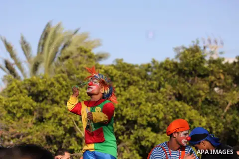 A Palestinian man dressed as a clown takes part during a cultural carnival organized by Gaza Municipality in Gaza City April 1, 2016. Photo by Mohammed Asad