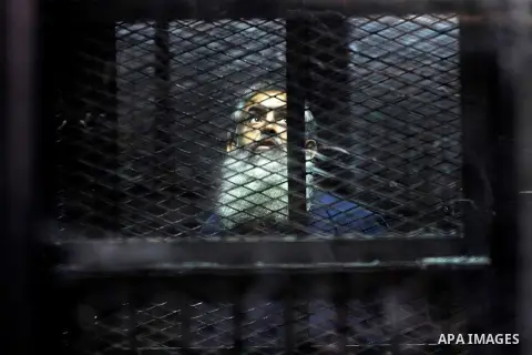 Egypt's Salafi leader and former presidential candidate Hazem Salah Abu Ismail looks on from the defendant cage during his trial in Cairo on April 2, 2016. An egyptian court considers today, Saturday the first trial sess...