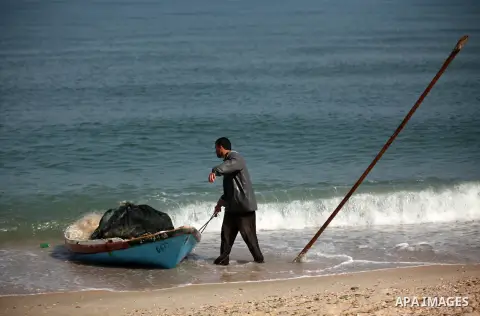 A Palestinian fisherman rides his fishing boat at the beach of Gaza City on April 03, 2016. Israel on Sunday extended the distance it permits Gaza fishermen to head out to sea along certain parts of the coastline of the...