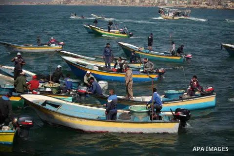 Palestinian fishermen ride their fishing boat at the beach of Gaza City on April 03, 2016. Israel on Sunday extended the distance it permits Gaza fishermen to head out to sea along certain parts of the coastline of the e...