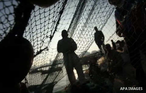 Palestinian fishermen pull their net at the beach in Gaza City, on April 4, 2016. Israel on Sunday extended the distance it permits Gaza fishermen to head out to sea along certain parts of the coastline of the enclave, w...