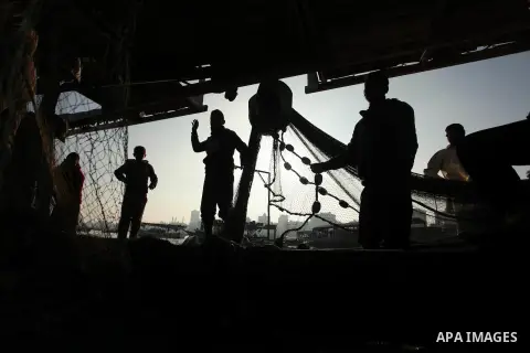 Palestinian fishermen pull their net at the beach in Gaza City, on April 4, 2016. Israel on Sunday extended the distance it permits Gaza fishermen to head out to sea along certain parts of the coastline of the enclave, w...