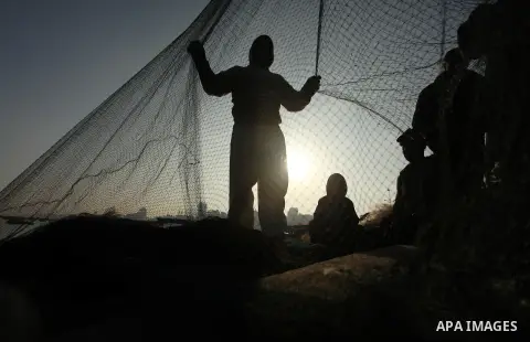 Palestinian fishermen pull their net at the beach in Gaza City, on April 4, 2016. Israel on Sunday extended the distance it permits Gaza fishermen to head out to sea along certain parts of the coastline of the enclave, w...