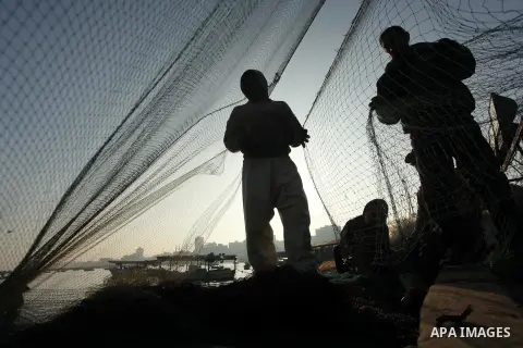 Palestinian fishermen pull their net at the beach in Gaza City, on April 4, 2016. Israel on Sunday extended the distance it permits Gaza fishermen to head out to sea along certain parts of the coastline of the enclave, w...
