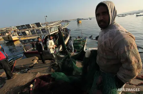 Palestinian fishermen pull their net at the beach in Gaza City, on April 4, 2016. Israel on Sunday extended the distance it permits Gaza fishermen to head out to sea along certain parts of the coastline of the enclave, w...