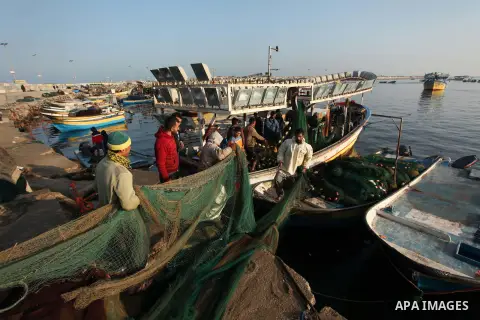 Palestinian fishermen pull their net at the beach in Gaza City, on April 4, 2016. Israel on Sunday extended the distance it permits Gaza fishermen to head out to sea along certain parts of the coastline of the enclave, w...