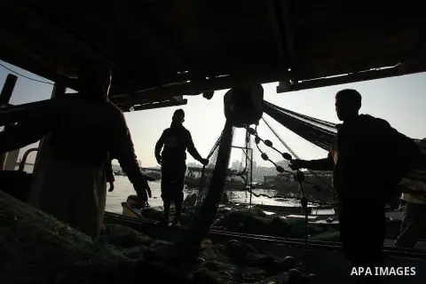 Palestinian fishermen pull their net at the beach in Gaza City, on April 4, 2016. Israel on Sunday extended the distance it permits Gaza fishermen to head out to sea along certain parts of the coastline of the enclave, w...