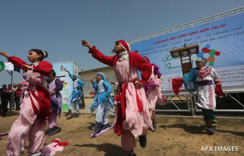 Palestinian children take part in a ceremony to mark Palestinian child day in Gaza seaport, on April 6, 2016. Photo by Mohammed Asad