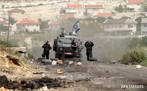 Israeli security forces take aim during clashes with Palestinian protesters following a weekly demonstration against the expropriation of Palestinian land by Israel in the village of Kfar Qaddum, near Nablus, in the occu...