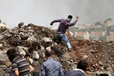 Palestinian protestesr hurl stones towards Israeli security forces during clashes following a weekly demonstration against the expropriation of Palestinian land by Israel in the village of Kfar Qaddum, near Nablus, in th...