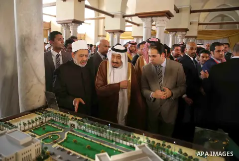 A handout picture made available by al-Azhar media center on April 9, 2016 shows the Grand Imam of al-Azhar Sheikh Ahmed al-Tayeb and Saudi King Salman bin Abdulaziz visiting the mosque at al-Azhar headquarters, the most...