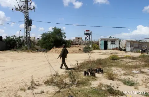 Members of Palestinian security forces stand guard in front of the Gaza-Egypt border in Rafah in the southern Gaza Strip, on April 14, 2016. Senior Hamas leader Ismail Haniyeh confirmed that Hamas spares no measures to p...