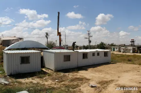 Palestinian workers place containers as new sites for Palestinian security forces in front of the Gaza-Egypt border in Rafah in the southern Gaza Strip, on April 14, 2016. Senior Hamas leader Ismail Haniyeh confirmed tha...