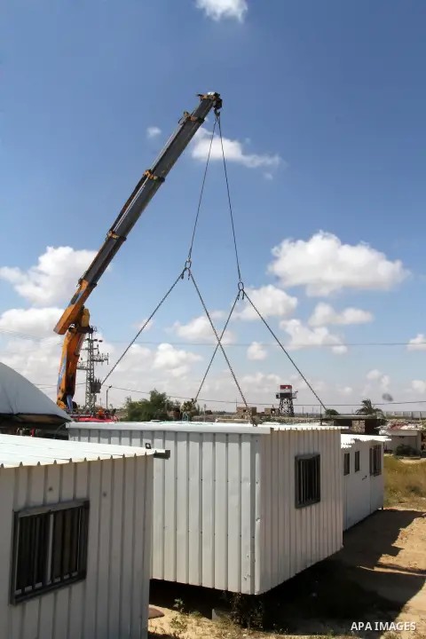 Palestinian workers place containers as new sites for Palestinian security forces in front of the Gaza-Egypt border in Rafah in the southern Gaza Strip, on April 14, 2016. Senior Hamas leader Ismail Haniyeh confirmed tha...