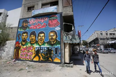 Palestinian men look graffiti marking Palestinian Prisoner Day in Gaza City on April 17, 2016. Photo by Mohammed Asad