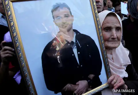 Palestinians hold pictures of Palestinians detained in Israeli prisons during a demonstration to mark Palestinian Prisoner Day in the West Bank city of Nablus on April 17, 2016. Photo by Nedal Eshtayah