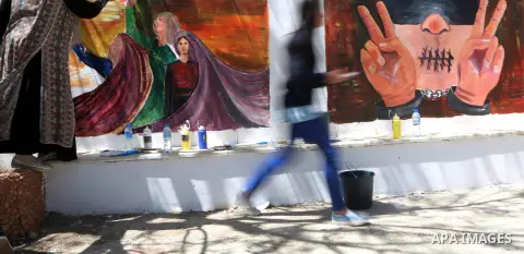 A Palestinian artist paints graffiti at school to mark Palestinian Prisoner Day in the West Bank city of Ramallah on April 17, 2016. Photo by Shadi Hatem