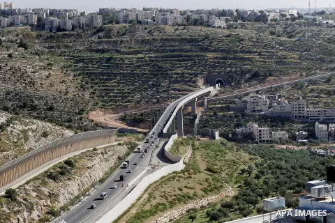 Israeli workers place a new section of Israel's separation concrete barrier in the Cremisan Valley, adjacent to the Christian Palestinian town of Beit Jala on April 17, 2016. The original route of the barrier was slated...