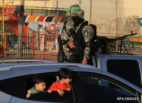 Members of the Ezzedine al-Qassam Brigades, the military wing of the Palestinian Islamist movement Hamas patrol during sunset at the beach of the Mediterranean sea on the coast of Gaza city on April 17, 2016. Photo by Ya...