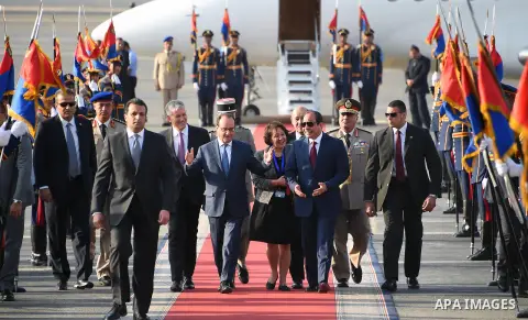 A handout picture made available by the Egyptian Presidency on 18 April 2016 shows Egyptian President Abdel Fattah al-Sisi (L) and his French counterpart Francois Hollande (2-L) reviewing a guard of honor during a welcom...
