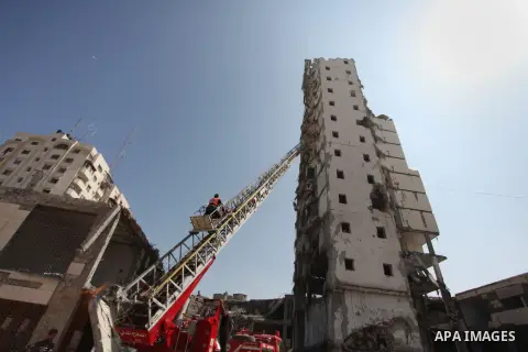 Palestinian emergency personnel take part in a drill in a building which was destroyed during the 50-day war between Israel and Hamas militants in the summer of 2014, in Gaza City, on April 19, 2016. Photo by Ashraf Amra