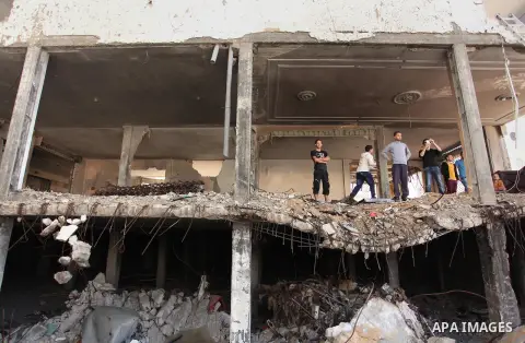 Palestinian emergency personnel take part in a drill in a building which was destroyed during the 50-day war between Israel and Hamas militants in the summer of 2014, in Gaza City, on April 19, 2016. Photo by Ashraf Amra
