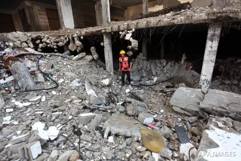 Palestinian emergency personnel take part in a drill in a building which was destroyed during the 50-day war between Israel and Hamas militants in the summer of 2014, in Gaza City, on April 19, 2016. Photo by Ashraf Amra