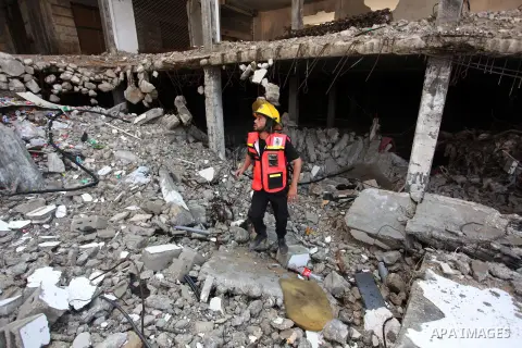 Palestinian emergency personnel take part in a drill in a building which was destroyed during the 50-day war between Israel and Hamas militants in the summer of 2014, in Gaza City, on April 19, 2016. Photo by Ashraf Amra