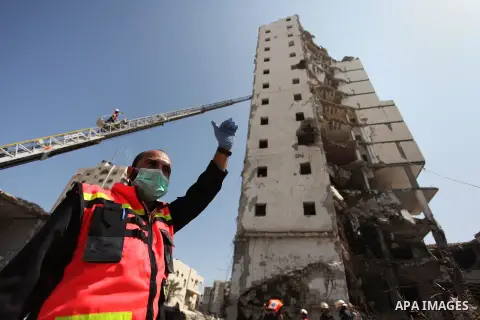 Palestinian emergency personnel take part in a drill in a building which was destroyed during the 50-day war between Israel and Hamas militants in the summer of 2014, in Gaza City, on April 19, 2016. Photo by Ashraf Amra