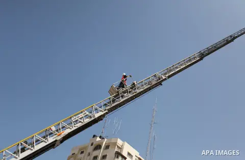 Palestinian emergency personnel take part in a drill in a building which was destroyed during the 50-day war between Israel and Hamas militants in the summer of 2014, in Gaza City, on April 19, 2016. Photo by Ashraf Amra
