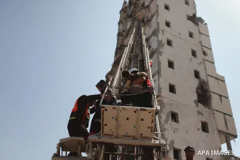 Palestinian emergency personnel take part in a drill in a building which was destroyed during the 50-day war between Israel and Hamas militants in the summer of 2014, in Gaza City, on April 19, 2016. Photo by Ashraf Amra