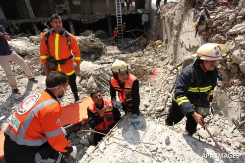Palestinian emergency personnel take part in a drill in a building which was destroyed during the 50-day war between Israel and Hamas militants in the summer of 2014, in Gaza City, on April 19, 2016. Photo by Ashraf Amra