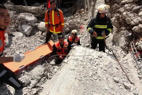 Palestinian emergency personnel take part in a drill in a building which was destroyed during the 50-day war between Israel and Hamas militants in the summer of 2014, in Gaza City, on April 19, 2016. Photo by Ashraf Amra
