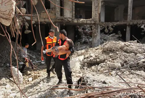 Palestinian emergency personnel take part in a drill in a building which was destroyed during the 50-day war between Israel and Hamas militants in the summer of 2014, in Gaza City, on April 19, 2016. Photo by Ashraf Amra