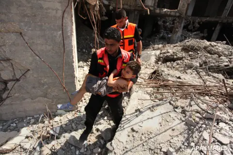 Palestinian emergency personnel take part in a drill in a building which was destroyed during the 50-day war between Israel and Hamas militants in the summer of 2014, in Gaza City, on April 19, 2016. Photo by Ashraf Amra