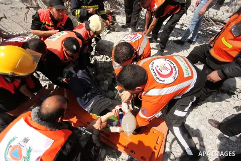 Palestinian emergency personnel take part in a drill in a building which was destroyed during the 50-day war between Israel and Hamas militants in the summer of 2014, in Gaza City, on April 19, 2016. Photo by Ashraf Amra