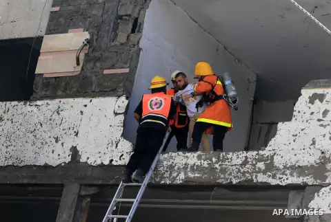 Palestinian emergency personnel take part in a drill in a building which was destroyed during the 50-day war between Israel and Hamas militants in the summer of 2014, in Gaza City, on April 19, 2016. Photo by Ashraf Amra