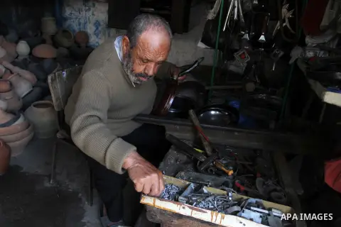A Palestinian man works at his work-shop in a market in Rafah in the southern Gaza strip, April 19, 2016. Photo by Abed Rahim Khatib