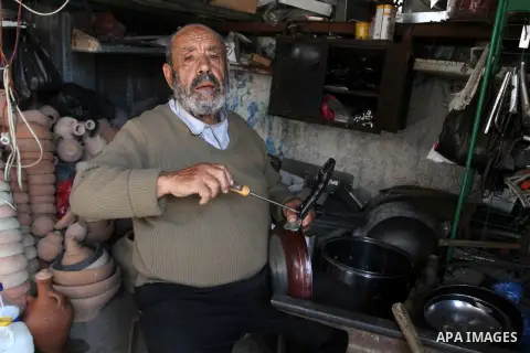 A Palestinian man works at his work-shop in a market in Rafah in the southern Gaza strip, April 19, 2016. Photo by Abed Rahim Khatib