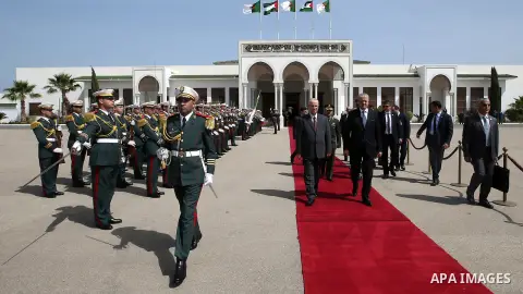 Algerian Prime Minister Abdelmalek Sellal walks alongside with Palestinian Prime Minister Rami Hamdallah before leaving Algerian Houari Boumediene International Airport in the capital Algiers on April 19, 2016. Photo by...