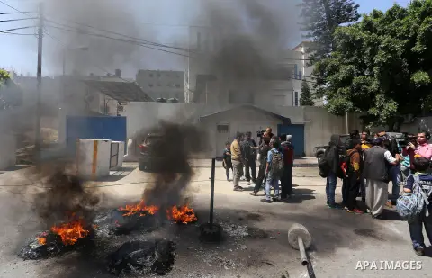 Palestinian owners of houses which were destroyed during the recent Israeli war, take part in a protest, in front of high commissioner for human rights headquarters, in Gaza City on April 20, 2016. Israeli occupation pri...