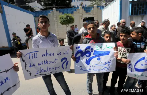 Palestinian owners of houses which were destroyed during the recent Israeli war, take part in a protest, in front of high commissioner for human rights headquarters, in Gaza City on April 20, 2016. Israeli occupation pri...