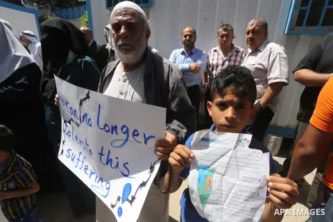 Palestinian owners of houses which were destroyed during the recent Israeli war, take part in a protest, in front of high commissioner for human rights headquarters, in Gaza City on April 20, 2016. Israeli occupation pri...