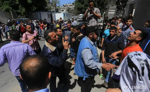 Palestinian owners of houses which were destroyed during the recent Israeli war, burn tires during a protest, in front of high commissioner for human rights headquarters, in Gaza City on April 20, 2016. Israeli occupatio...